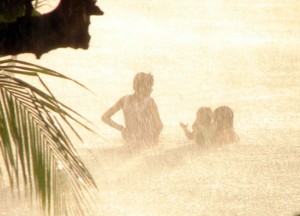 Children playing in a rainstorm - Half Moon Bay, Roatan, Honduras